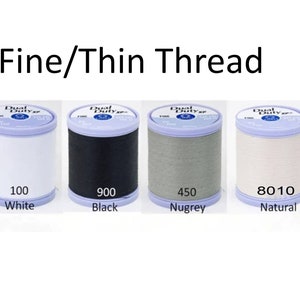 May include: Four spools of fine thread in white, black, gray, and natural colors. Each spool is labeled with a number and color name: 100 White, 900 Black, 450 Nugrey, and 8010 Natural.