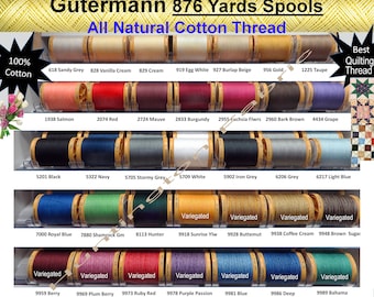 Puede incluir: Una exhibición de carretes Gutermann de 802 metros de hilo de algodón natural. La imagen muestra una variedad de colores, incluyendo Gris Arena, Crema Vainilla y Azul Real. El texto "Best Quilting Thread" es visible.