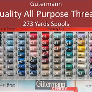 May include: A display of Gutermann sew-all thread spools in various colors. The spools are labeled with numbers and are arranged in rows. The text "Sew-all Thread" and "Economy Size" are visible at the top of the image. The spools are 273 yards each.