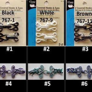 May include: Three sets of covered hooks and eyes in black, white, and brown. The hooks and eyes are extra large and are labelled 767-1, 767-9, and 767-11. Below the hooks and eyes are three sets of decorative closures in purple, green, and blue.