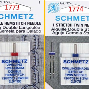 May include: Two packages of Schmetz sewing machine needles. One package is labeled "1 Double Hemstitch Needle" and the other "1 Stretch Twin Needle." Both packages have the Schmetz logo and product information in multiple languages.