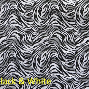 May include: Black and white abstract pattern with wavy lines resembling a zebra print.