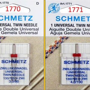 May include: Two packages of Schmetz universal twin needles. Each package has a clear plastic case with a red top. The text on the packages includes "1 Universal Twin Needle" and the needle size.