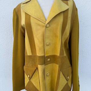May include: Mustard yellow and brown vintage jacket with a patchwork design. The jacket features a leather collar and front panels, with a knit fabric on the sleeves. It has two front pockets and three buttons down the front.
