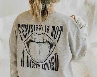 May include: Gray sweatshirt with a black graphic of a mouth with a tongue sticking out and the text "Feminism is not a dirty word".