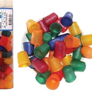 May include: A collection of colorful plastic thimbles in various shades of red, orange, yellow, green, and blue. The thimbles are arranged in a random pattern on a white surface.