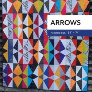 May include: A colourful quilt pattern with a geometric design featuring black, white, red, yellow, blue, green, and orange triangles. The quilt is titled "Arrows" and has a finished size of 64 x 74 inches.
