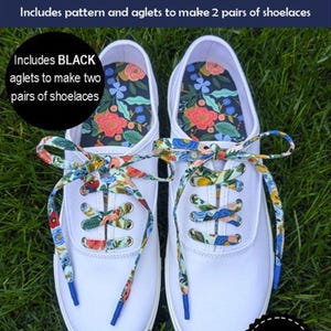 May include: A pair of white canvas sneakers featuring floral patterned shoelaces with blue aglets. The interior of the shoes displays a matching floral print. Text on the image reads: Lace Up! Includes pattern and aglets to make 2 pairs of shoelaces.