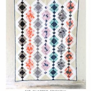 May include: A quilting pattern for a quilt called "The Kelly Quilt" by Erica Jackman. The quilt is made with fat quarters and comes in baby, lap, and twin sizes. The quilt is a geometric design with black, white, grey, pink, blue, and orange fabric.