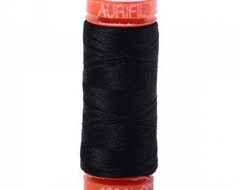 Könnte beinhalten: Eine Spule schwarzen Fadens mit einem orangefarbenen Etikett mit der Aufschrift "Aurifil 100% Baumwolle".