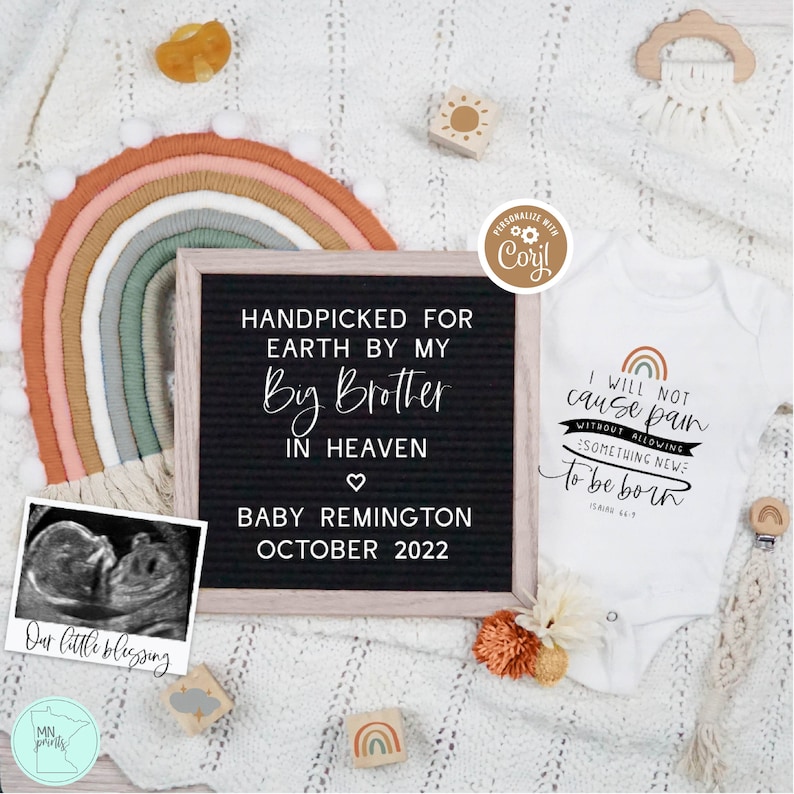 May include: A black letter board with the text "Handpicked for Earth by my Big Brother in Heaven" and "Baby Remington October 2022". A white onesie with the text "I will not cause pain without allowing something new to be born" and a rainbow graphic. A black and white ultrasound image is in the lower left corner.