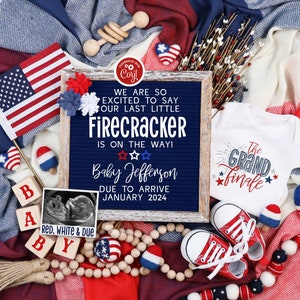 May include: A red, white, and blue themed baby announcement with the text "We are so excited to say our last little Firecracker is on the way! Baby Jefferson due to arrive January 2024". The announcement is surrounded by red, white, and blue decorations, including a baby onesie, a wooden rattle, and a string of wooden beads.