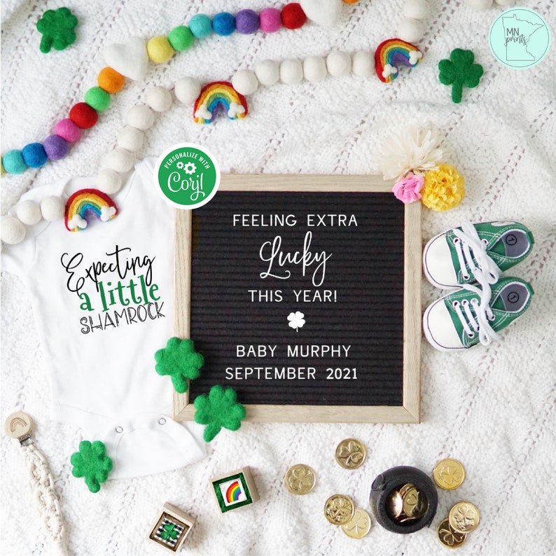 May include: A white onesie with the text "Expecting a little shamrock" and a rainbow graphic. A black letter board with the text "Feeling extra lucky this year! Baby Murphy September 2021". Green felt shamrocks, a pot of gold coins, and a pair of green baby shoes.