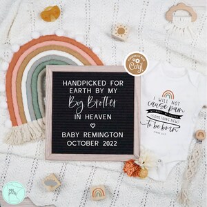 May include: A white onesie with a rainbow and the text "I will not cause pain without allowing something new to be born" and a reference to Isaiah 44:9. A letter board with the text "Handpicked for Earth by my Big Brother in Heaven" and "Baby Remington October 2022".