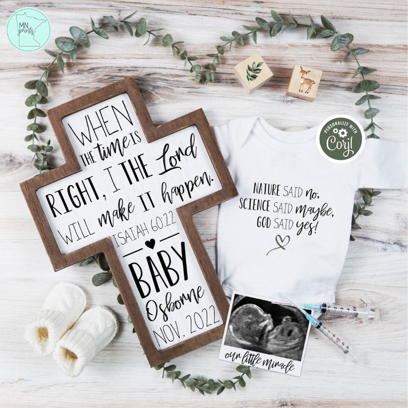 May include: A wooden cross with a white background and black text. The text reads "When the time is right, I the Lord will make it happen. Isaiah 60:22". Below the text is a heart and the words "Baby Osborne Nov. 2022".