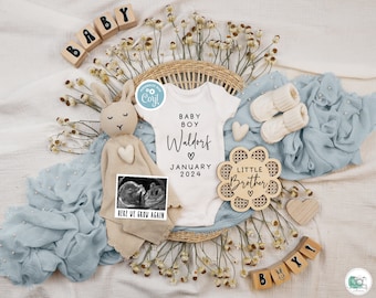 May include: A baby announcement with a white onesie that says "Baby Boy Waldorf" with a heart and "January 2024". There is a wooden sign that says "Little Brother" with a heart. There is a stuffed bunny with a heart on its chest and a sonogram picture in a frame that says "Here We Grow Again". There are wooden blocks that spell out "Baby" and "Boy!" and a blue and white blanket.