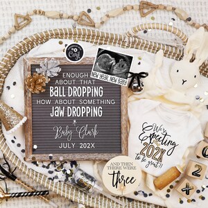 May include: A baby announcement with a gray letter board that reads "ENOUGH ABOUT THAT BALL DROPPING HOW ABOUT SOMETHING JAW DROPPING Baby Clark JULY 202X." A white onesie says "We're Expecting 202X to be great!!" with wooden blocks spelling out "202X."