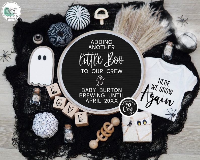 May include: A black and white Halloween-themed baby announcement with a round sign that reads "Adding another little Boo to our crew. Baby Burton brewing until April 20XX". There are also black and white pumpkins, a ghost, and a baby onesie that reads "Here we grow again".