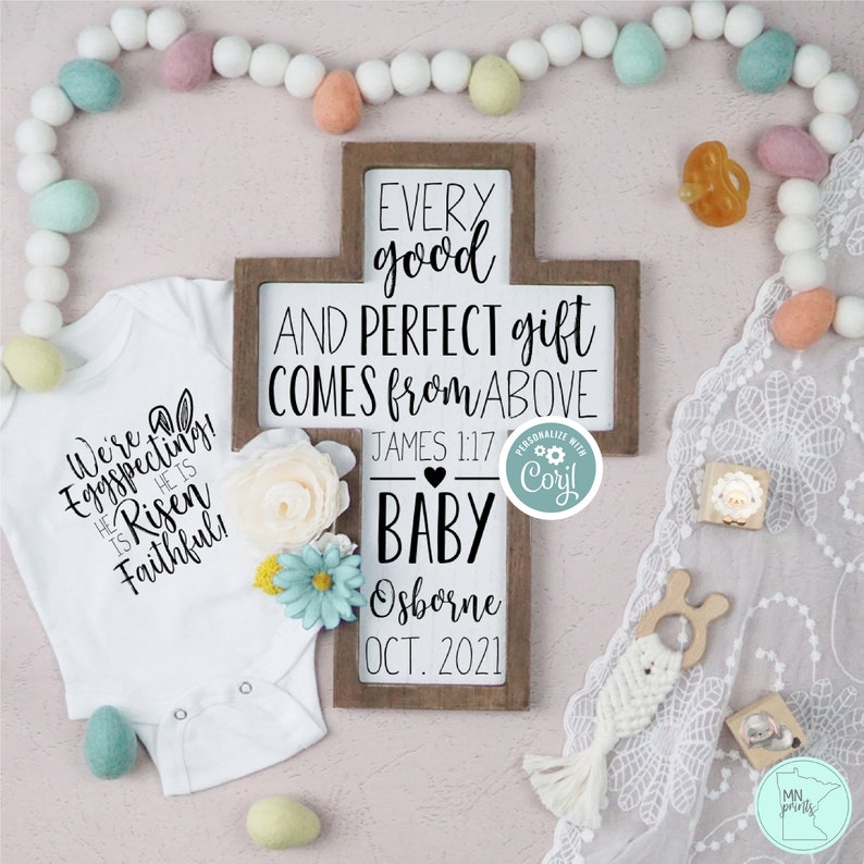 May include: A wooden cross sign with the text "Every good and perfect gift comes from above" with a heart and the text "James 1:17" below. The sign also has the text "Baby Osborne Oct. 2021".