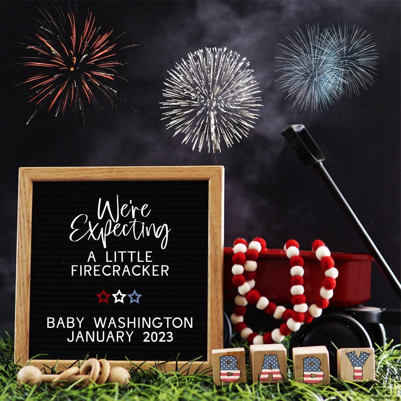 May include: A black letter board with the text "We're Expecting A Little Firecracker" and "Baby Washington January 2023". There are three red, white, and blue stars below the text. The letter board is sitting on a green grassy surface. There are red, white, and blue fireworks in the background. There are wooden blocks that spell out "BABY" in the foreground.
