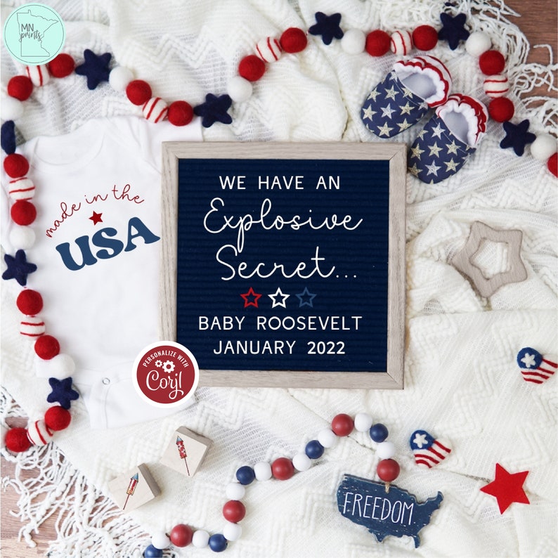 May include: A patriotic baby announcement with a white onesie that says "made in the USA." A letter board reveals "We Have an Explosive Secret... BABY ROOSEVELT JANUARY 2022." Red, white, and blue decorations include star-shaped booties and a garland.