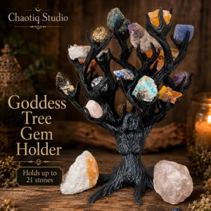 May include: A black resin sculpture shaped like a tree with a female figure integrated into the trunk, featuring branches that hold various raw gemstones. Text on the image reads: Chaotiq Studio, Goddess Tree Gem Holder, Holds up to 21 stones.