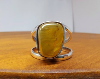 Minimalist sterling silver wire ring with natural green amber