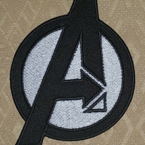 May include: Black and white embroidered iron-on patch featuring the Avengers logo, a stylized "A" inside a circle. The patch measures 10 x 7.5 cm.