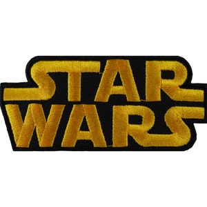 May include: A black and gold embroidered patch with the text "STAR WARS" in a bold, stylized font.