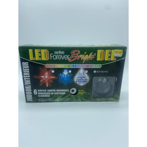 May include: A box of six acrylic LED lighted ornaments. The box is green and black with the words "LED Forever Bright DEL" and "Colour Changing LED" printed on it. The box also has images of the ornaments.