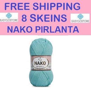 May include: A skein of light blue Nako Pirlanta yarn. The yarn is wrapped around a white label with the Nako logo and the word "Pirlanta" printed on it.