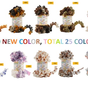 Puede incluir: Una colección de 25 ovillos de lana de colores en varios tonos de marrón, rosa, morado, azul y verde. La lana es esponjosa y texturizada, y los ovillos están dispuestos en dos filas de 10 y 5. El texto "10 NEW COLOR, TOTAL 25 COLOR" está impreso debajo de los ovillos.