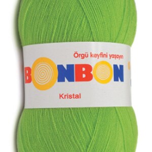 May include: A ball of bright green yarn with the brand name "BONBON" and the word "Kristal" printed on the label. The label also says "&Ouml;rg&uuml; keyfini yaşayın", which translates to "Live the joy of knitting" in English.