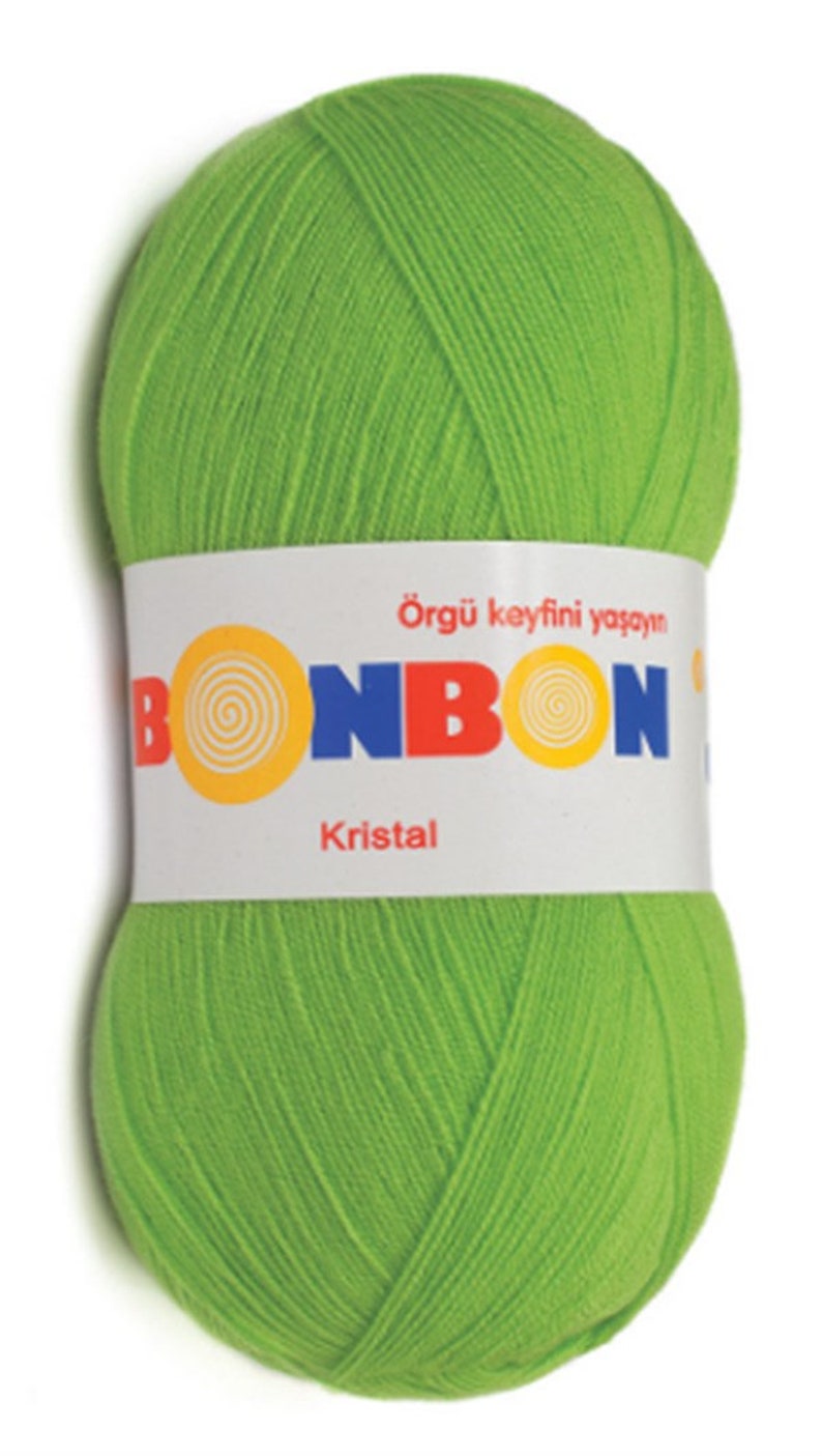 May include: A ball of bright green yarn with the brand name "BONBON" and the word "Kristal" printed on the label. The label also says "&Ouml;rg&uuml; keyfini yaşayın", which translates to "Live the joy of knitting" in English.