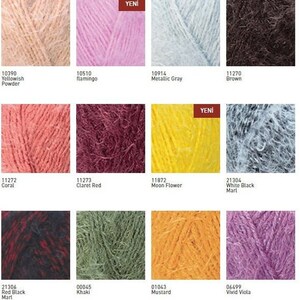 May include: A color chart of yarn samples in various colors, including yellow, pink, gray, brown, coral, red, yellow, white, black, red, green, orange, and purple. The chart is labeled with the color names and corresponding numbers.