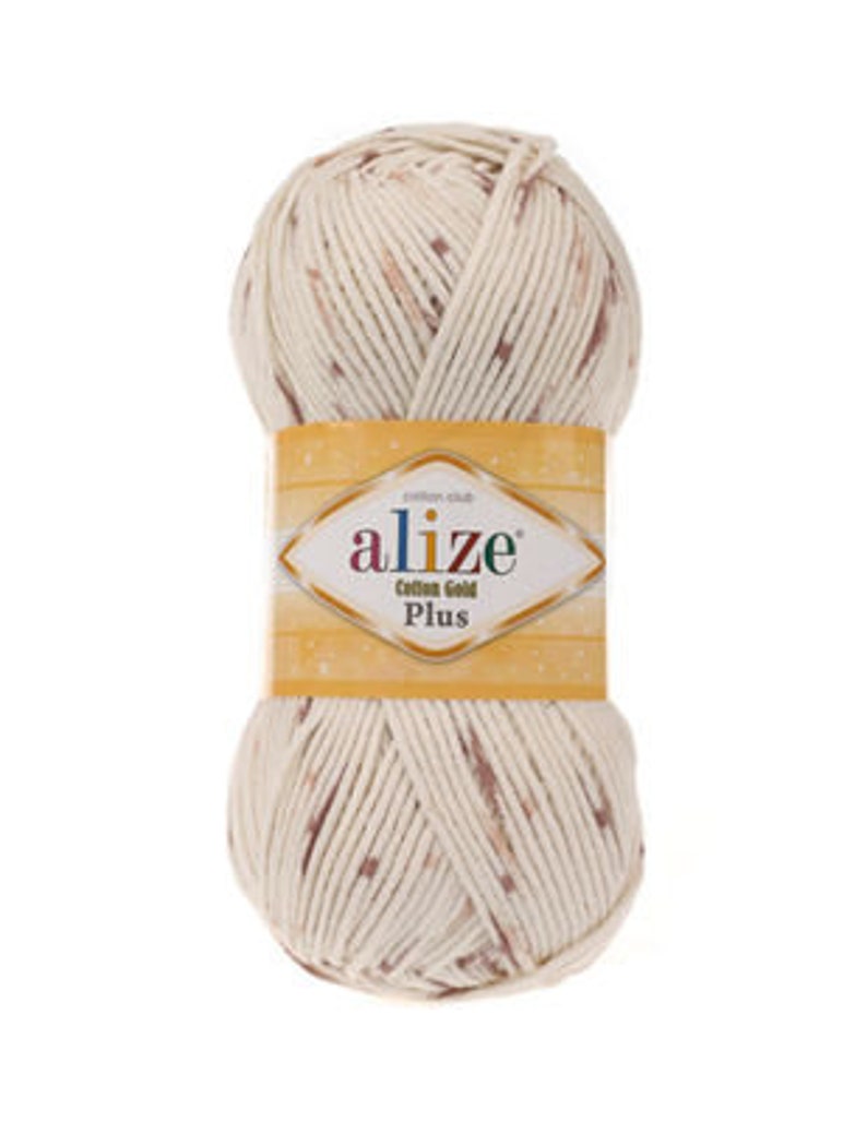 Puede incluir: Un ovillo de hilo de color crema con motas marrones. El hilo est&aacute; etiquetado como "Alize Cotton Gold Plus".