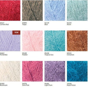 May include: A color chart of yarn samples in various shades of red, brown, blue, green, purple, pink, white, and orange. The yarn is a fuzzy, fluffy texture. The chart includes the color name and number for each sample.