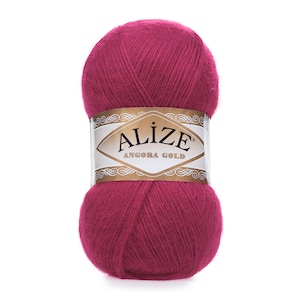 Puede incluir: Un ovillo de hilo rosa con una etiqueta dorada que dice "Alize Angora Gold".