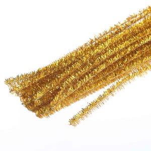May include: A bundle of metallic gold pipe cleaners featuring a fuzzy, textured surface. These flexible craft stems are constructed with a wire core covered in shiny, reflective gold synthetic fibers, arranged in a parallel, linear formation.