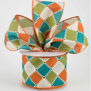 May include: A spool of wired ribbon featuring a repeating diamond pattern in shades of orange, teal, and light green. Each diamond shape is outlined with a white stitched design, creating a textured appearance on the fabric surface.