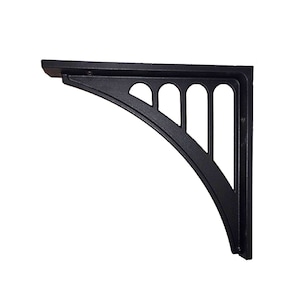 May include: Black metal shelf bracket with a decorative arched design and a cutout pattern. The bracket is made of cast iron and has a matte black finish.