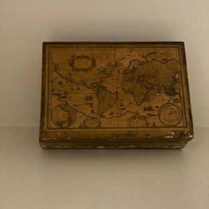 May include: A wooden box with a vintage world map design on the lid. The map is in brown and gold tones and features continents and islands.
