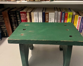 Rustic green wood farm stool with bootjack ends country bench