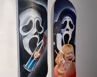 May include: Two black and white painted skateboards with a Ghostface character from the Scream movie franchise. The first skateboard shows Ghostface holding a knife with a bloody victim's head on the blade. The second skateboard shows Ghostface holding a knife and a woman on the phone screaming.