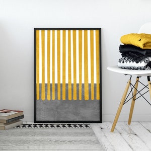 May include: A black framed print with a yellow and white striped design. The stripes are thick and vertical, and the bottom of the print has a gray background with yellow drips.