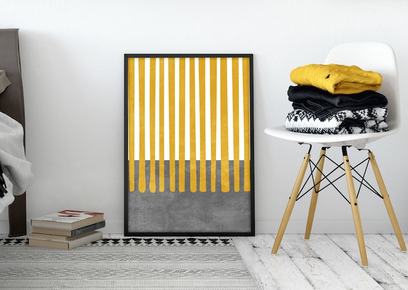 May include: A black framed print with a yellow and white striped design. The stripes are thick and vertical, and the bottom of the print has a gray background with yellow drips.