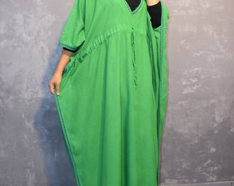 May include: A bright green kaftan featuring a V-neckline, short sleeves, and a drawstring waist. The garment is accented with dark green decorative trim along the neckline, sleeves, and hemline, creating a distinct contrast against the vibrant fabric.
