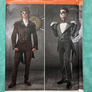 May include: Simplicity sewing pattern 1039 for costumes, featuring two variations: a brown jacket with goggles and a black tailcoat with a bat-shaped bowtie. The package displays size US 38-44, includes a barcode, and states it is designed and printed in the USA.