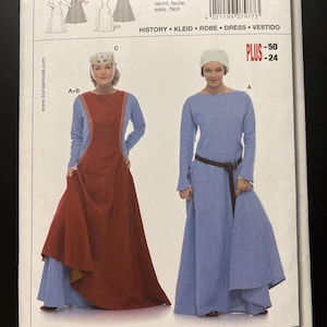 May include: A Burda 7977 sewing pattern envelope featuring historical dress designs. The cover displays two long-sleeved gowns, one with a red over-tunic and crown, and one with a blue dress and brown belt. Text includes 'HISTORY', 'KLEID', 'ROBE', 'DRESS', 'VESTIDO'.