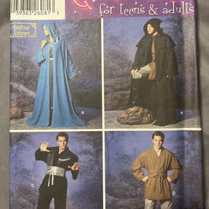 May include: A Simplicity sewing pattern envelope for costumes for teens and adults, model 3940. The cover features four variations of hooded robes and tunics in blue, black, and brown, with text including Costumes for teens & adults and Andrea Schewe.